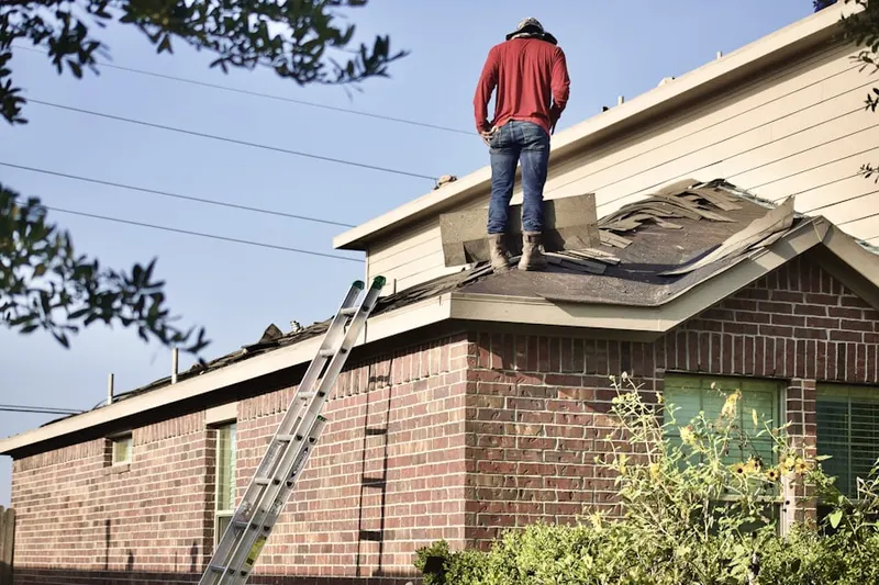 Professional roofer working on a residential roof in Mountaindale